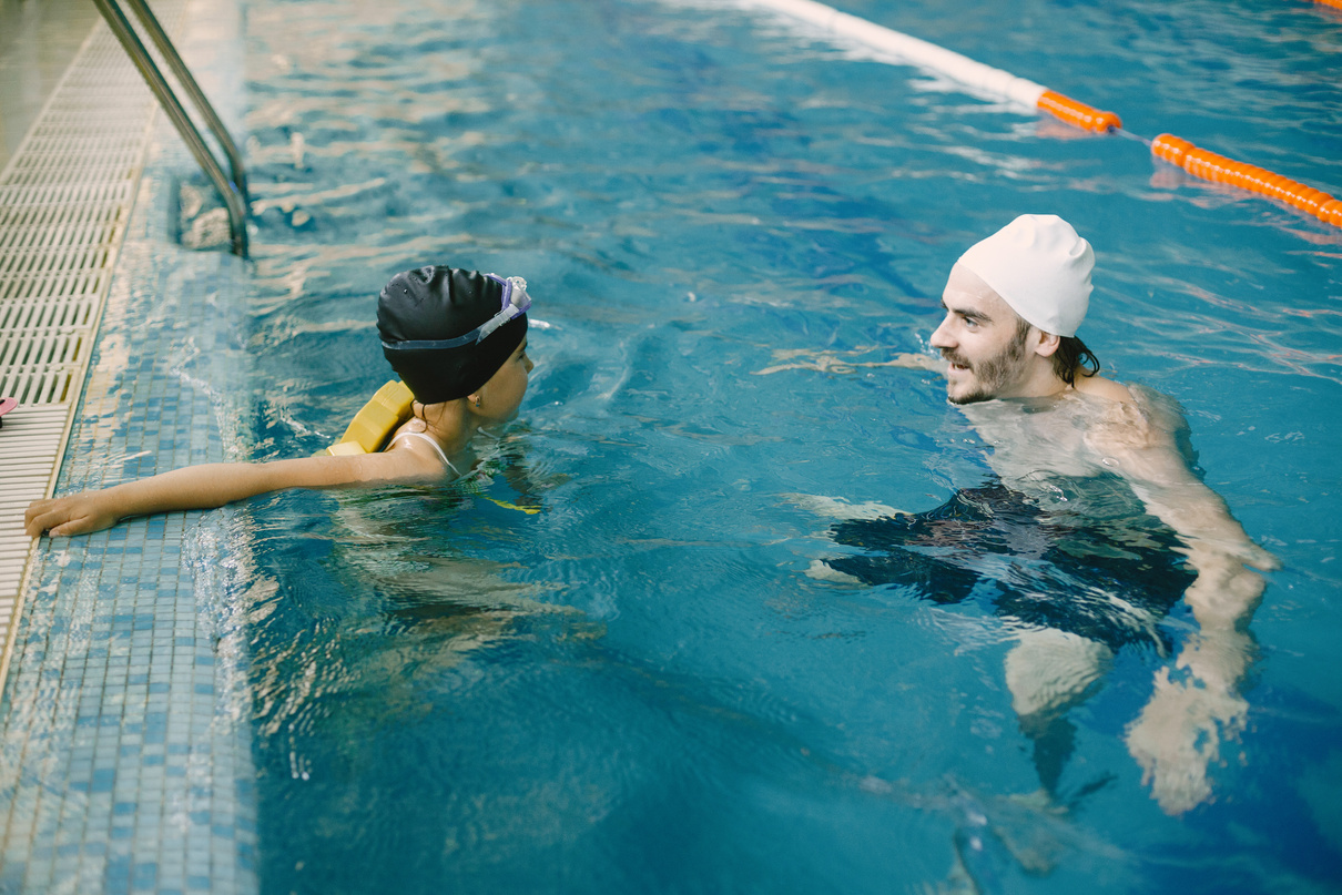 Swimming Instructor Teaching Child
